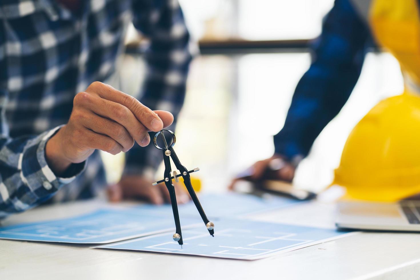 Engineer and Architect meeting working and pointing at a drawings in office for discussing. Engineering tools and construction concept,Engineers and Architects Brainstorm. photo