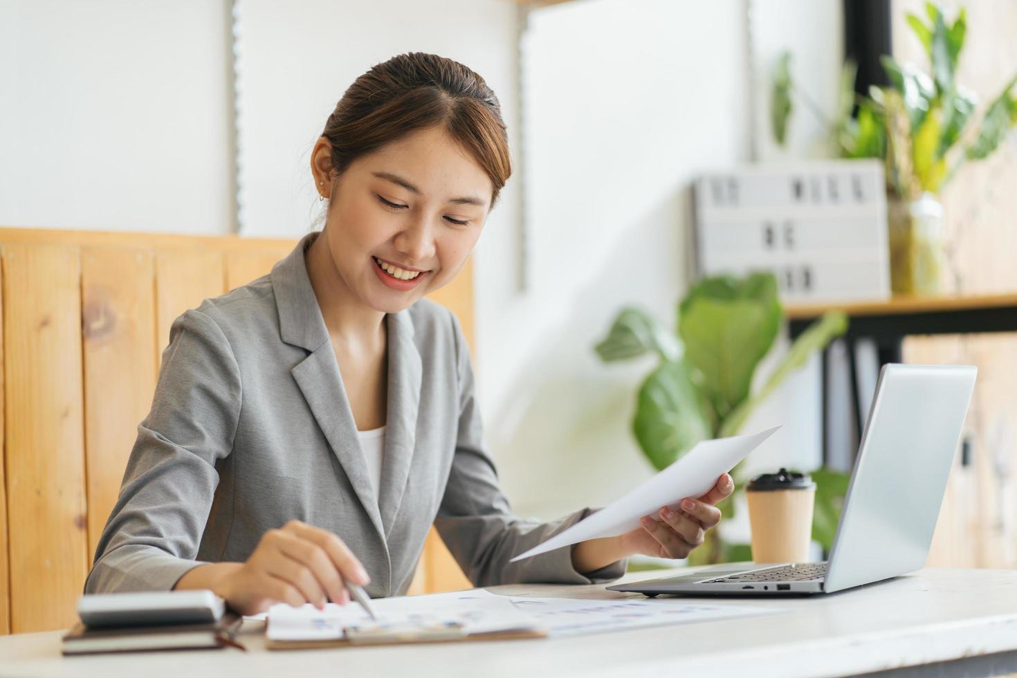 Portrait of charming successful cheerful focused girl working remotely creating finance it presentation report at home house flat indoor photo