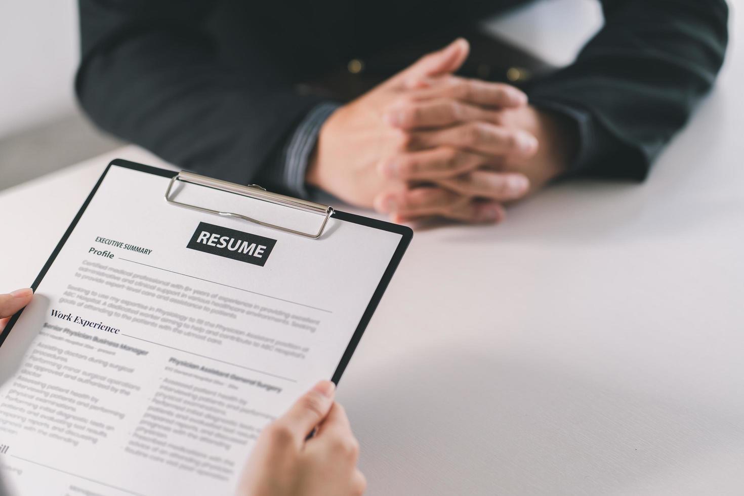 Cropped view of person holding pen and filling out application form on table photo