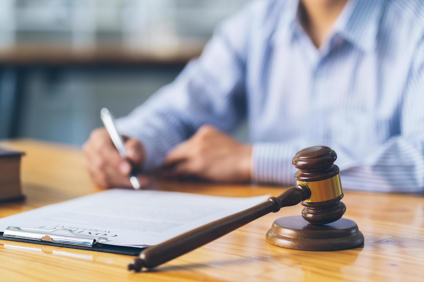 Business and lawyers discussing contract papers with brass scale on desk in office. Law, legal services, advice, justice and law concept. photo