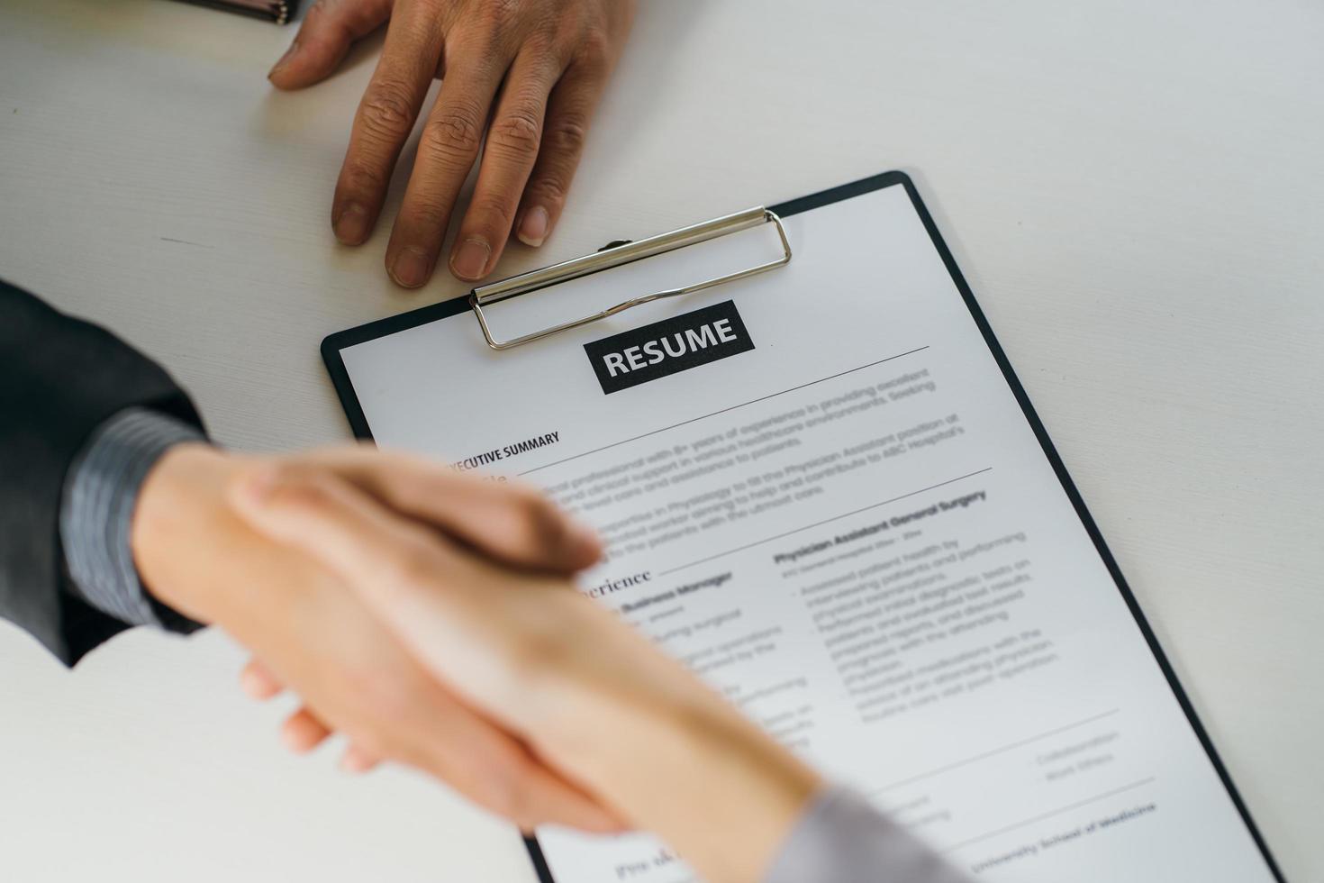 Close up businessman hands holding pen with document at meeting. Man making decision on business deal. Good business partners negotiation at job interview in office. photo