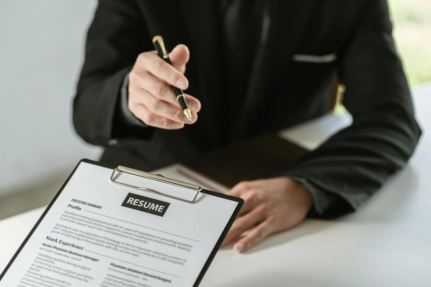 Cropped view of person holding pen and filling out application form on table photo
