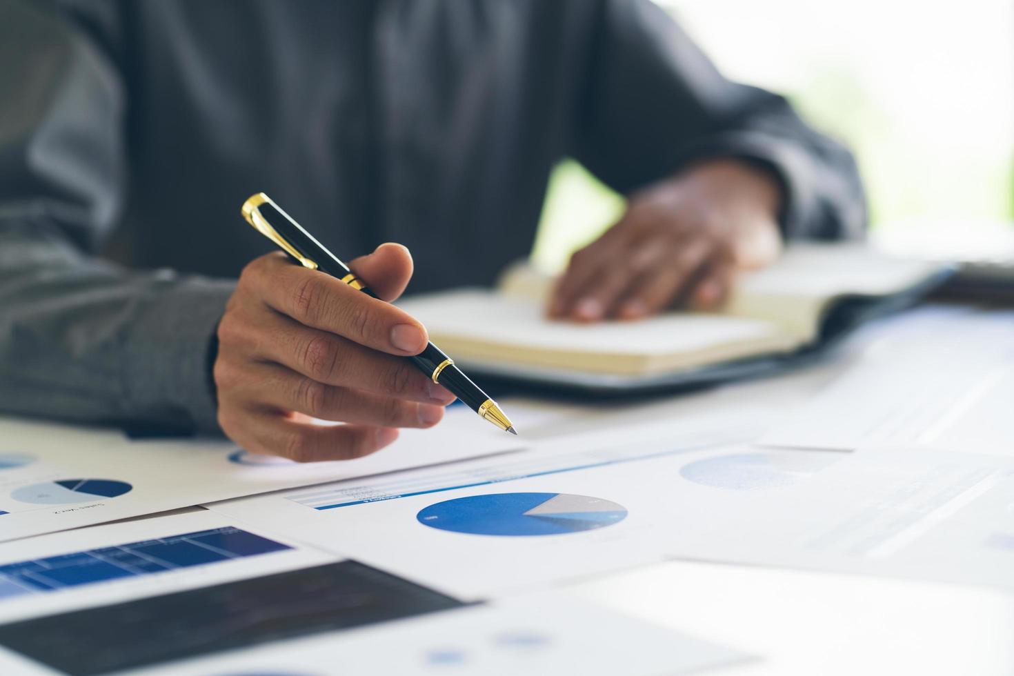 close up of hands gesturing while holding pen and presenting project work and disscus business of concept businessman in office photo