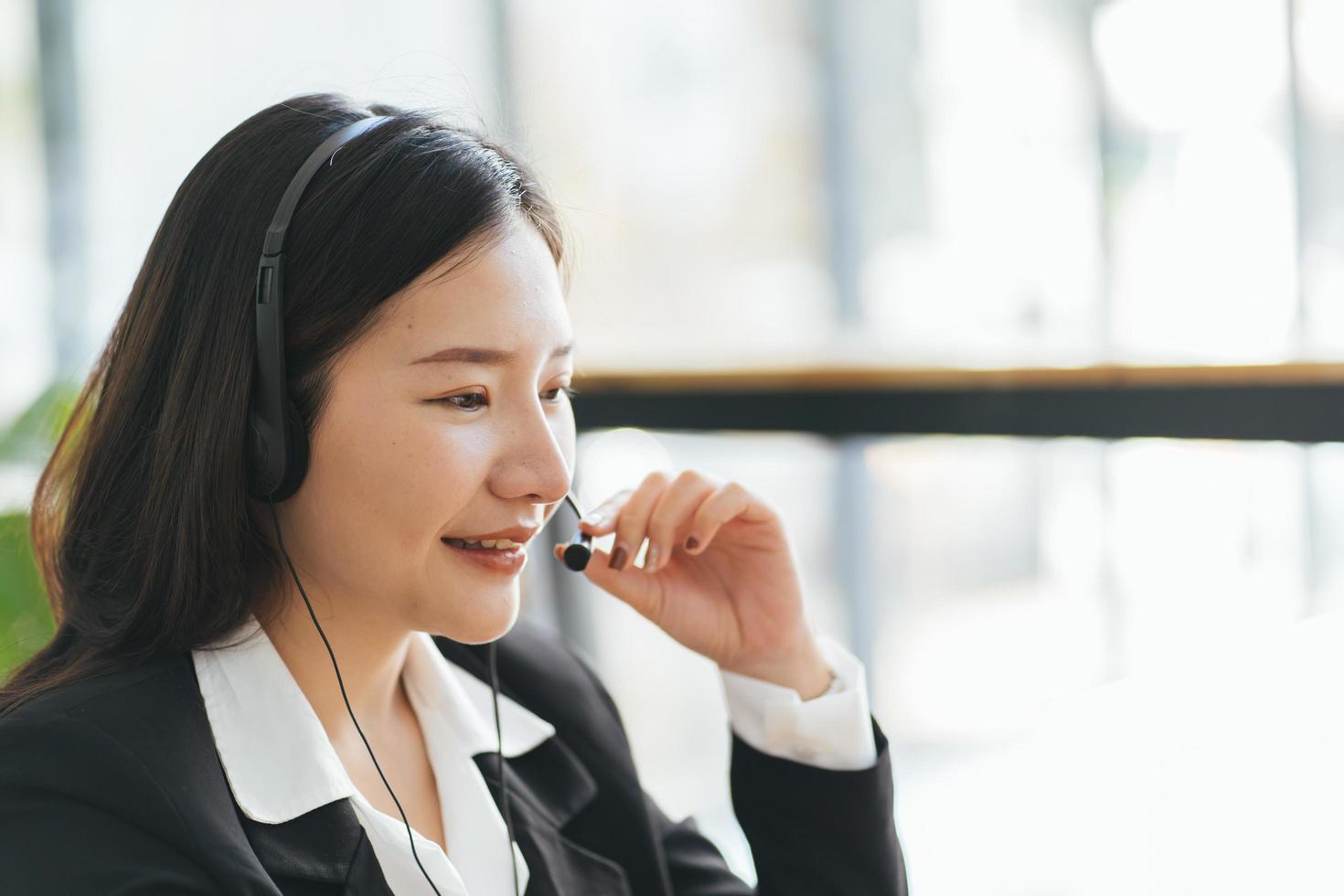 Young businesswoman discussing project details with clients via video call. photo