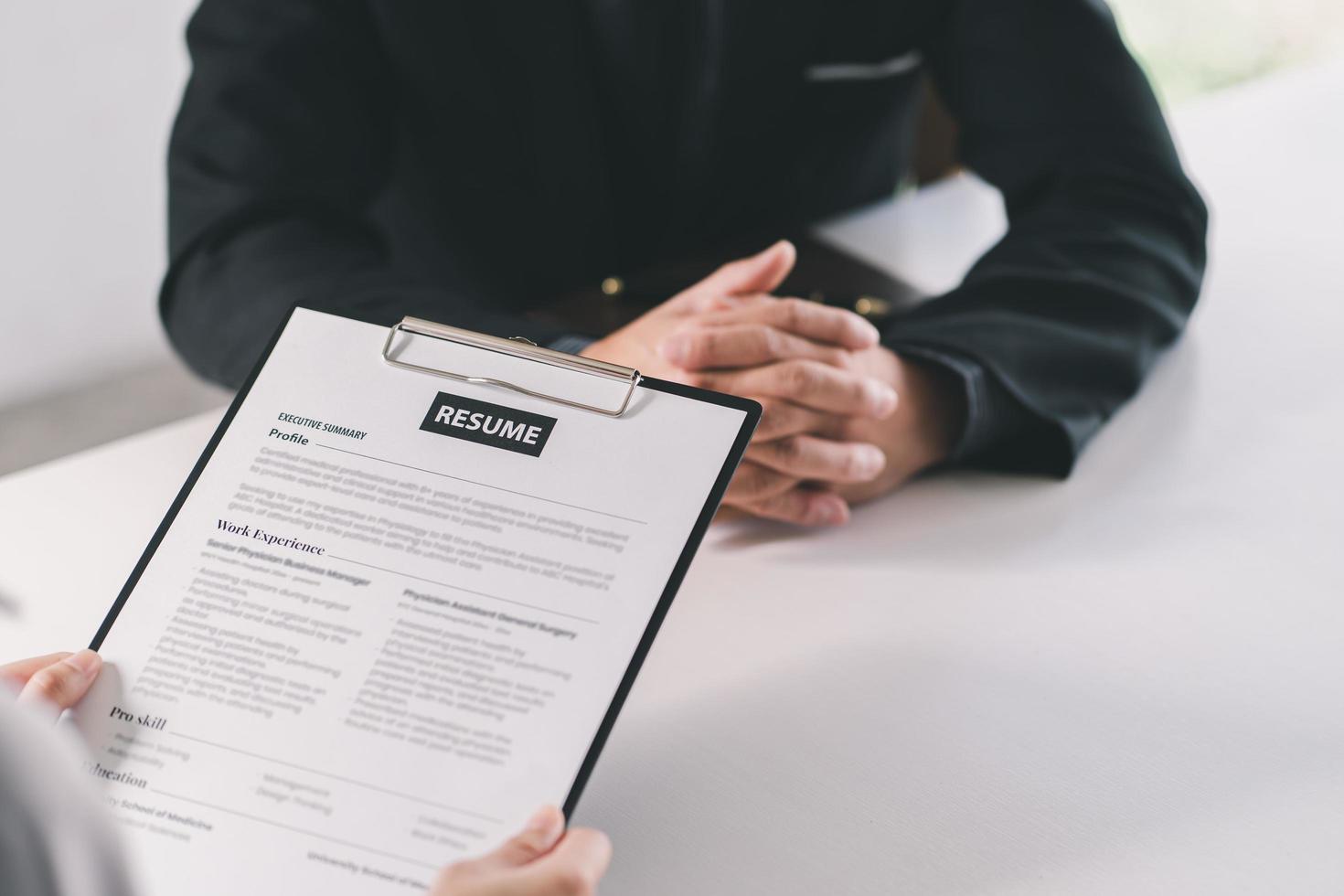 Cropped view of person holding pen and filling out application form on table photo