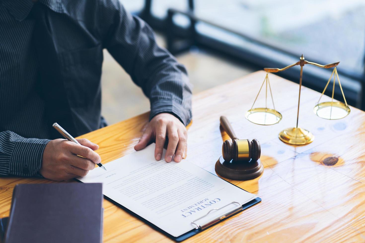 Judge gavel with Justice lawyers, Businessman in suit or lawyer working on a documents. Legal law, advice and justice concept. photo