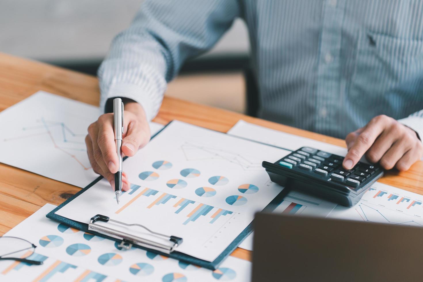 Financial businessman calculating corporate income tax data And analyzing charts of financial stocks that are in good condition with growth and progress, Investment in finance and accounting. photo