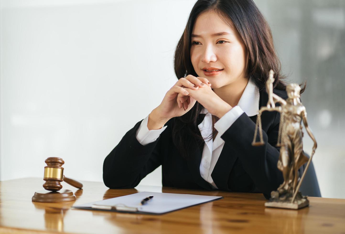 Serious female asian lawyer with smiling sitting at workplace and