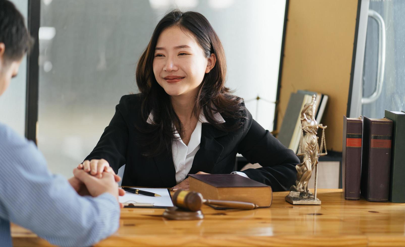 Lawyer business women shaking hands with clients, after finishing up a Consulting for insurance rent house. concept of home protection, family, insurance. photo