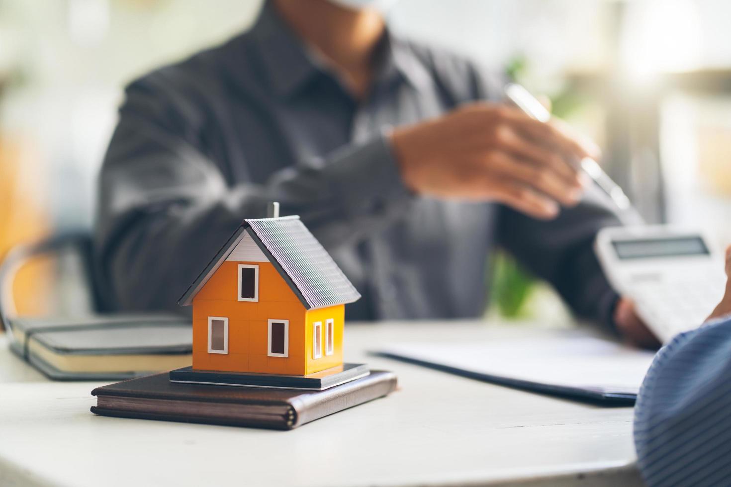 Real estate agent talked about the terms of the home purchase agreement and asked the customer to sign the documents to make the contract legally, Home sales and home insurance concept. photo