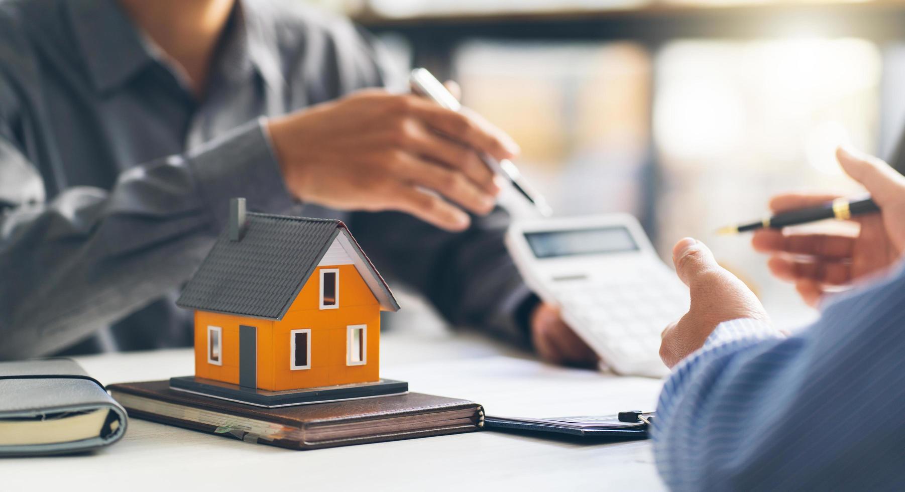 Real estate agent talked about the terms of the home purchase agreement and asked the customer to sign the documents to make the contract legally, Home sales and home insurance concept. photo