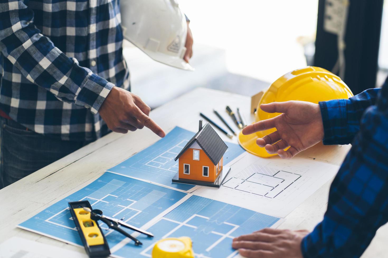 Concept architects, engineer holding pen pointing equipment architects On the desk with a blueprint in the office,Engineers and architects brainstorm work on blueprints. photo