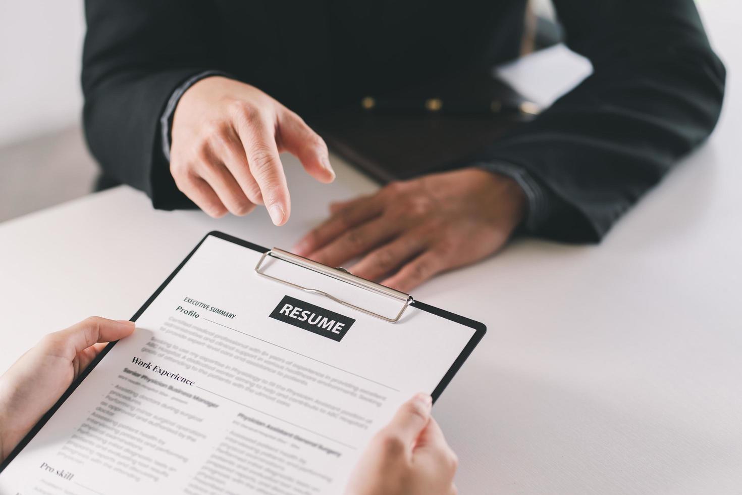 Close up businessman hands holding pen with document at meeting. Man making decision on business deal. Good business partners negotiation at job interview in office. photo