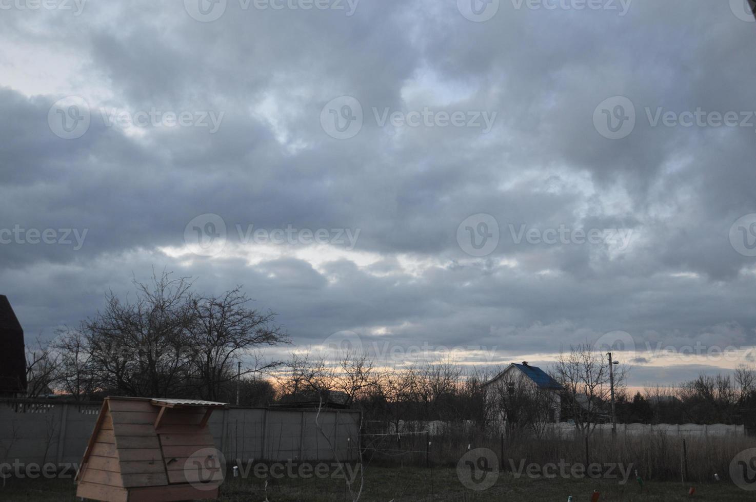 Thunderclouds in the evening on the sky in the village photo