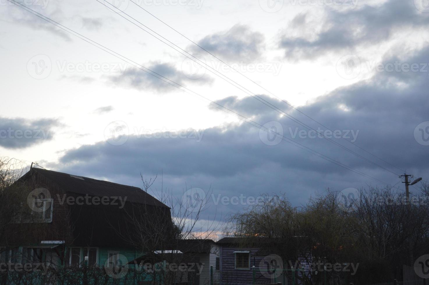 Thunderclouds in the evening on the sky in the village photo