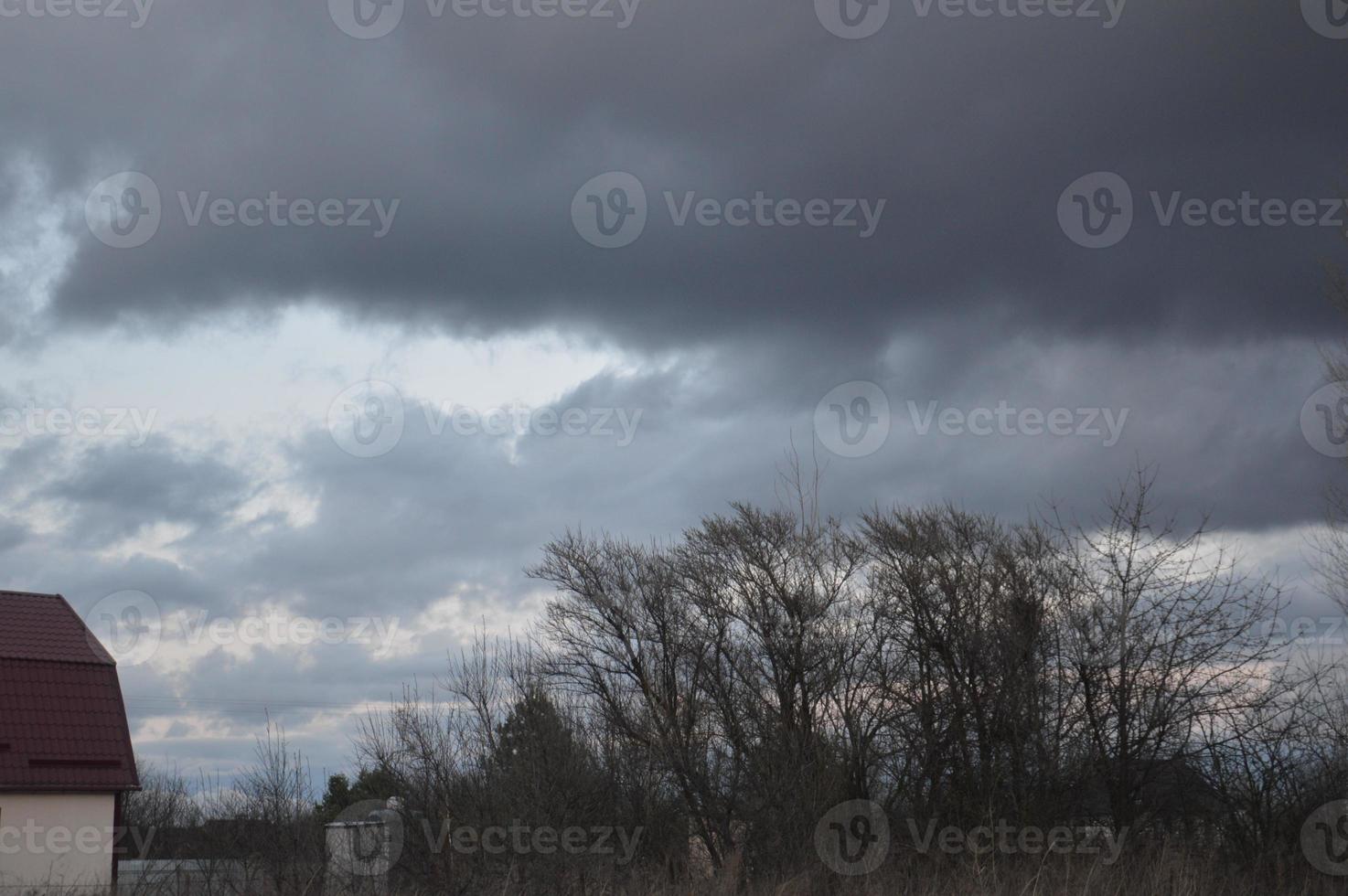 Thunderclouds in the evening on the sky in the village photo