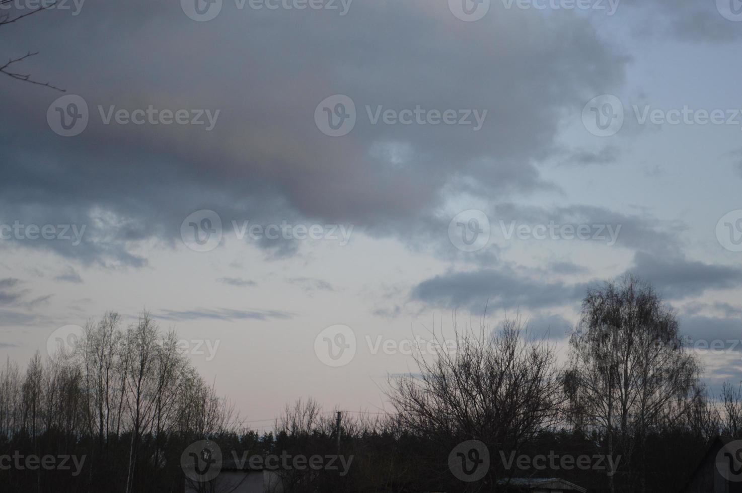 Thunderclouds in the evening on the sky in the village photo