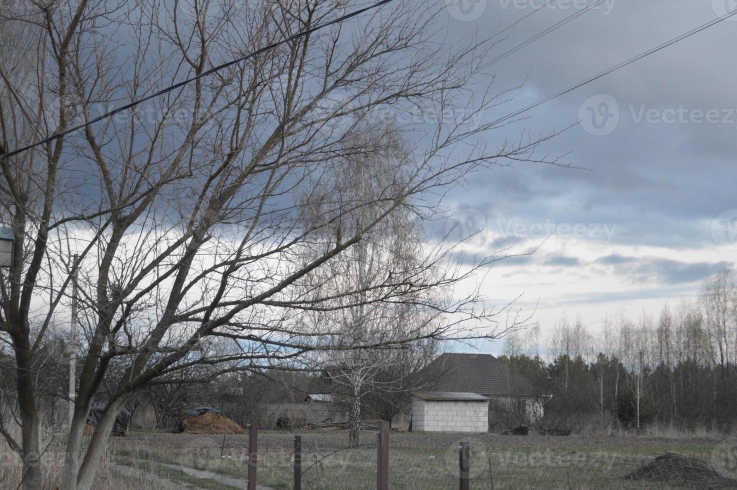 Thunderclouds in the evening on the sky in the village photo