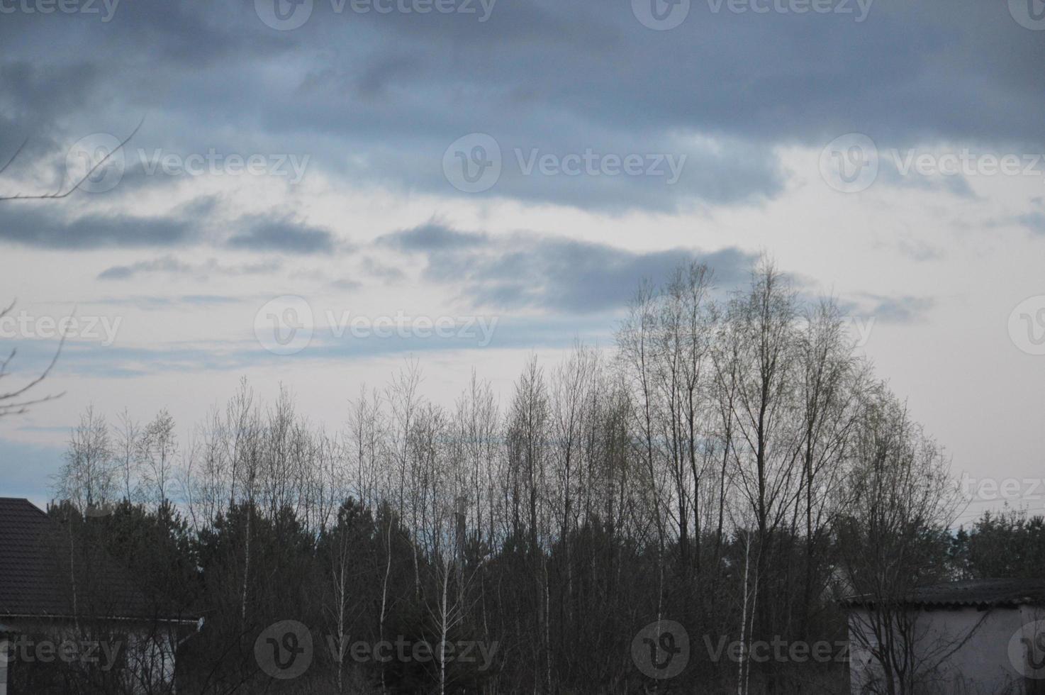 Thunderclouds in the evening on the sky in the village photo