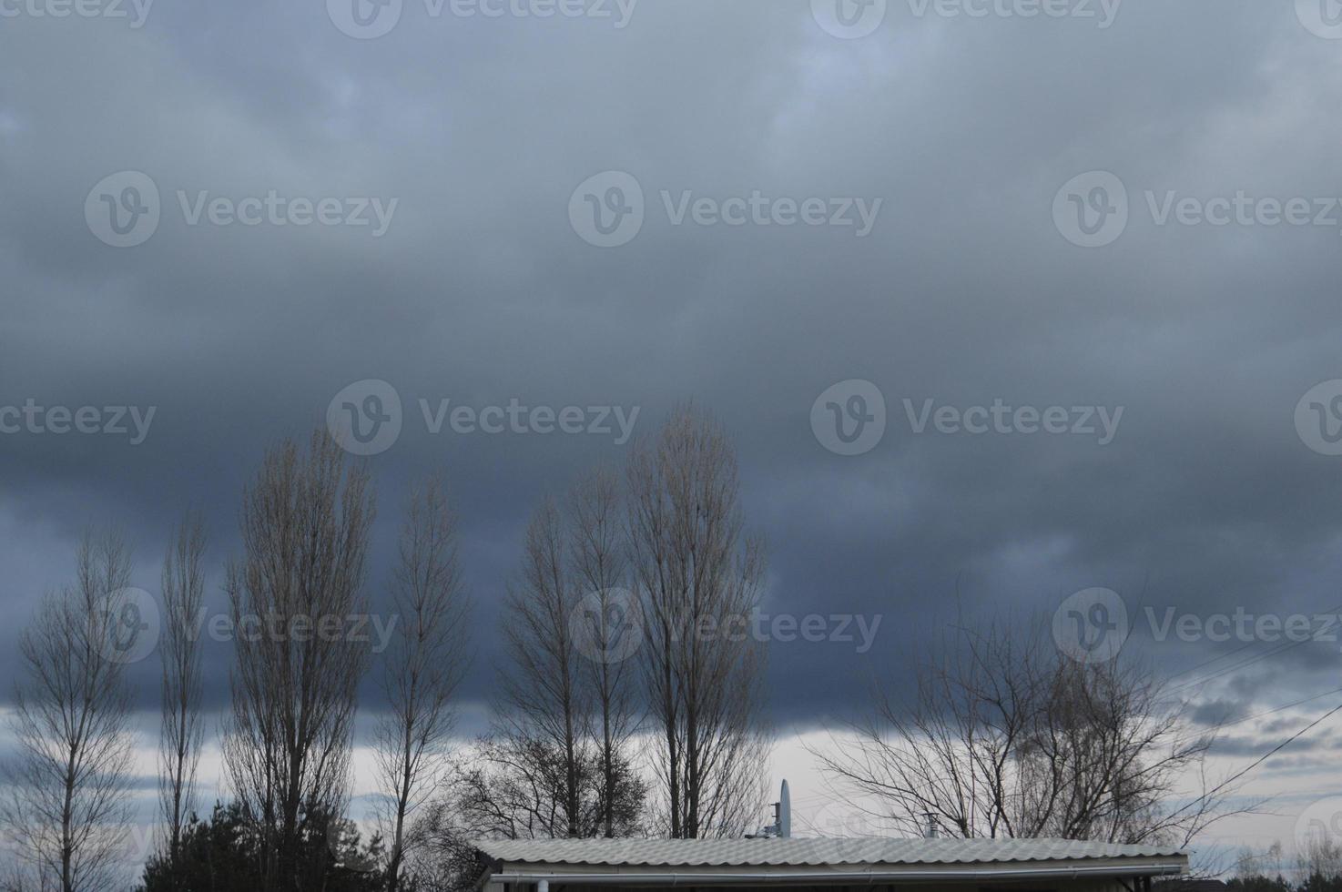 Thunderclouds in the evening on the sky in the village photo