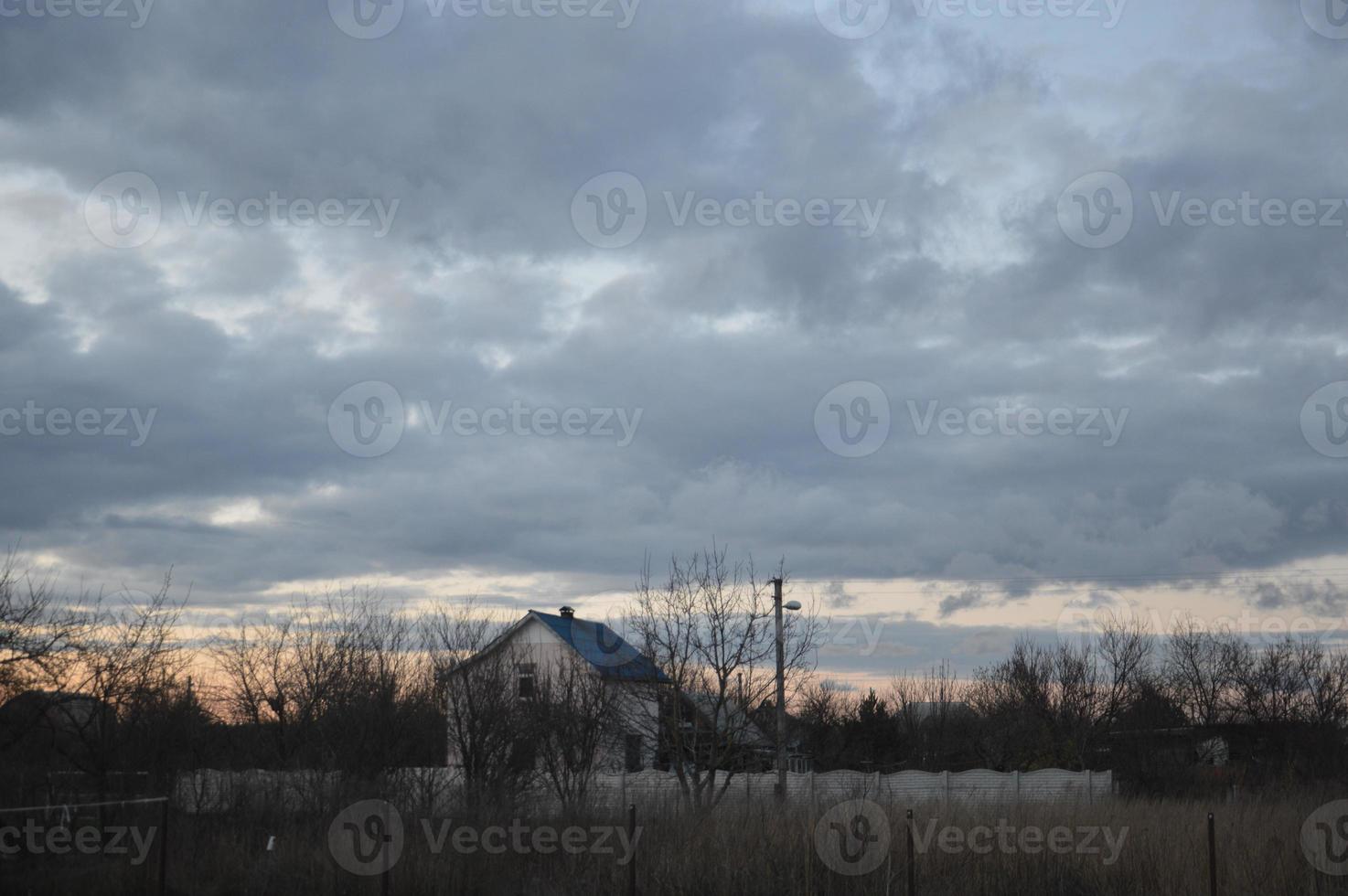 Thunderclouds in the evening on the sky in the village photo
