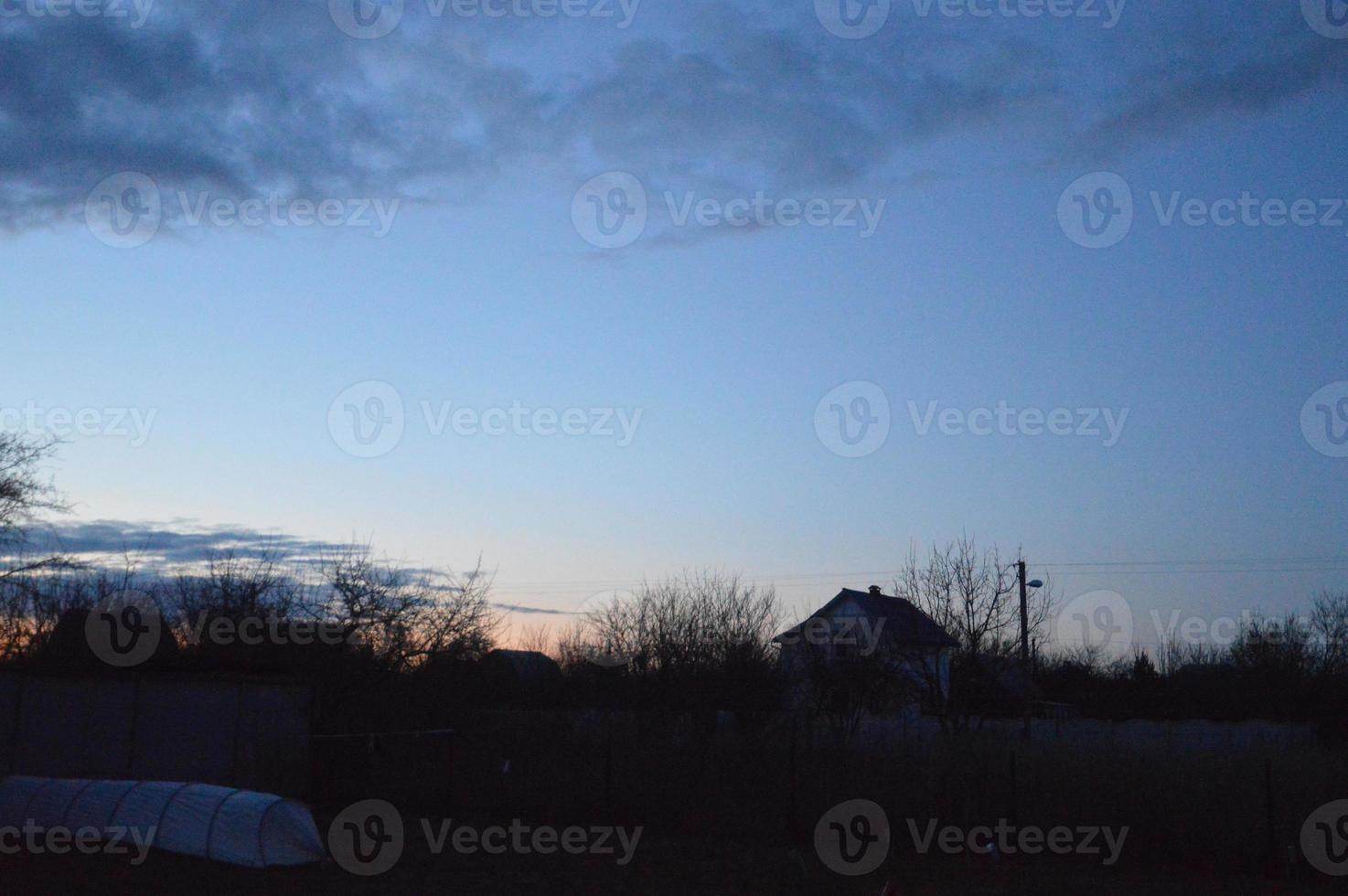 Thunderclouds in the evening on the sky in the village photo