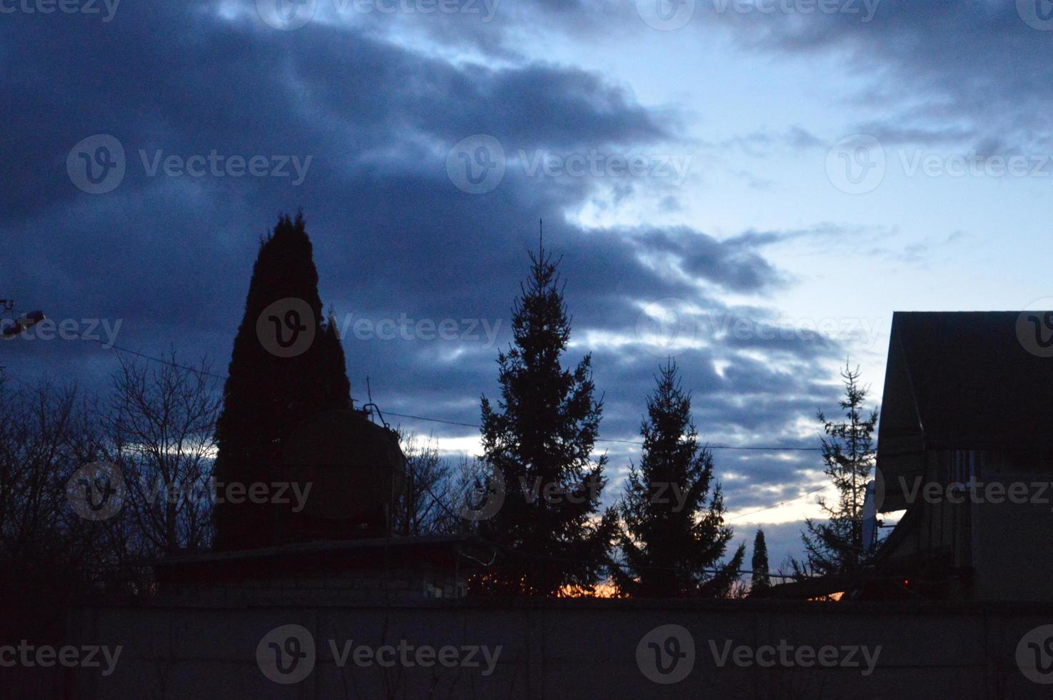 Thunderclouds in the evening on the sky in the village photo