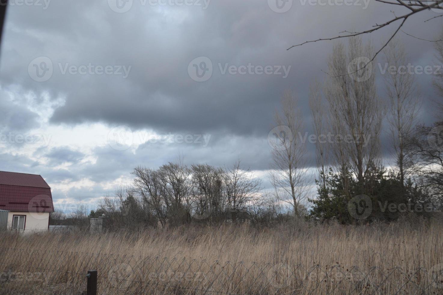 Thunderclouds in the evening on the sky in the village photo