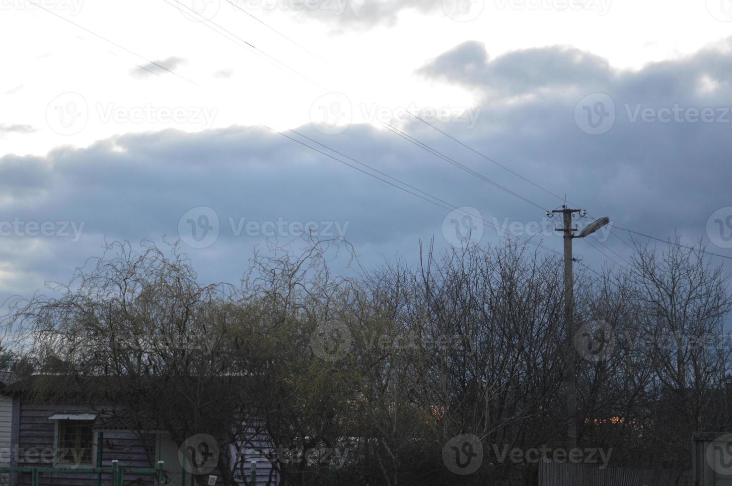 Thunderclouds in the evening on the sky in the village photo