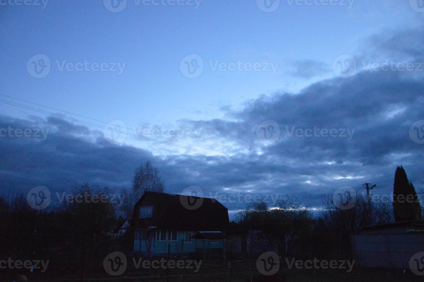 Thunderclouds in the evening on the sky in the village photo