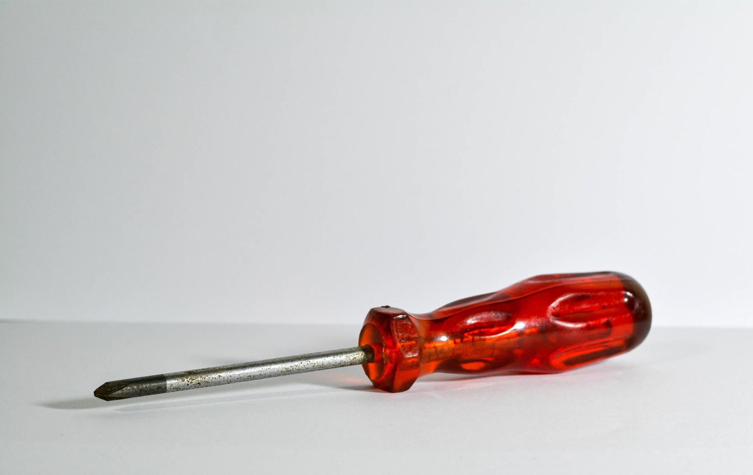 Screwdriver on a white background. Screwdriver with red handle. photo
