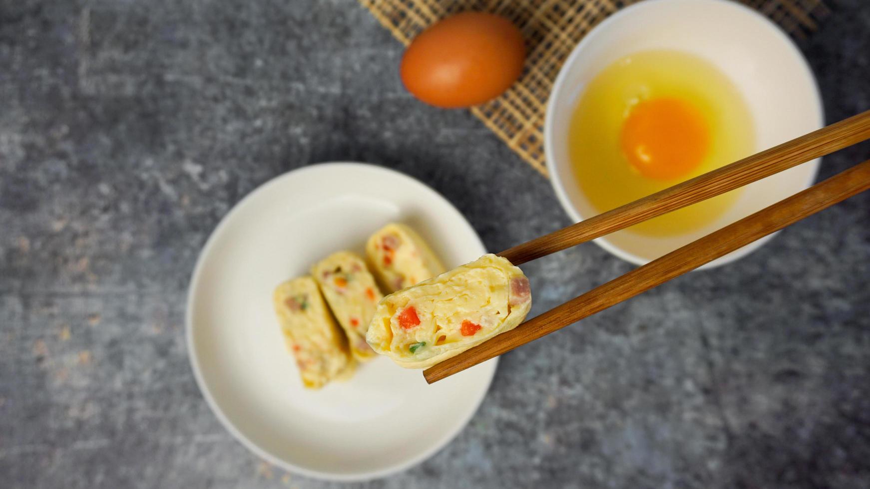 Selective focused Omelet, egg roll with vegetables and ham. photo