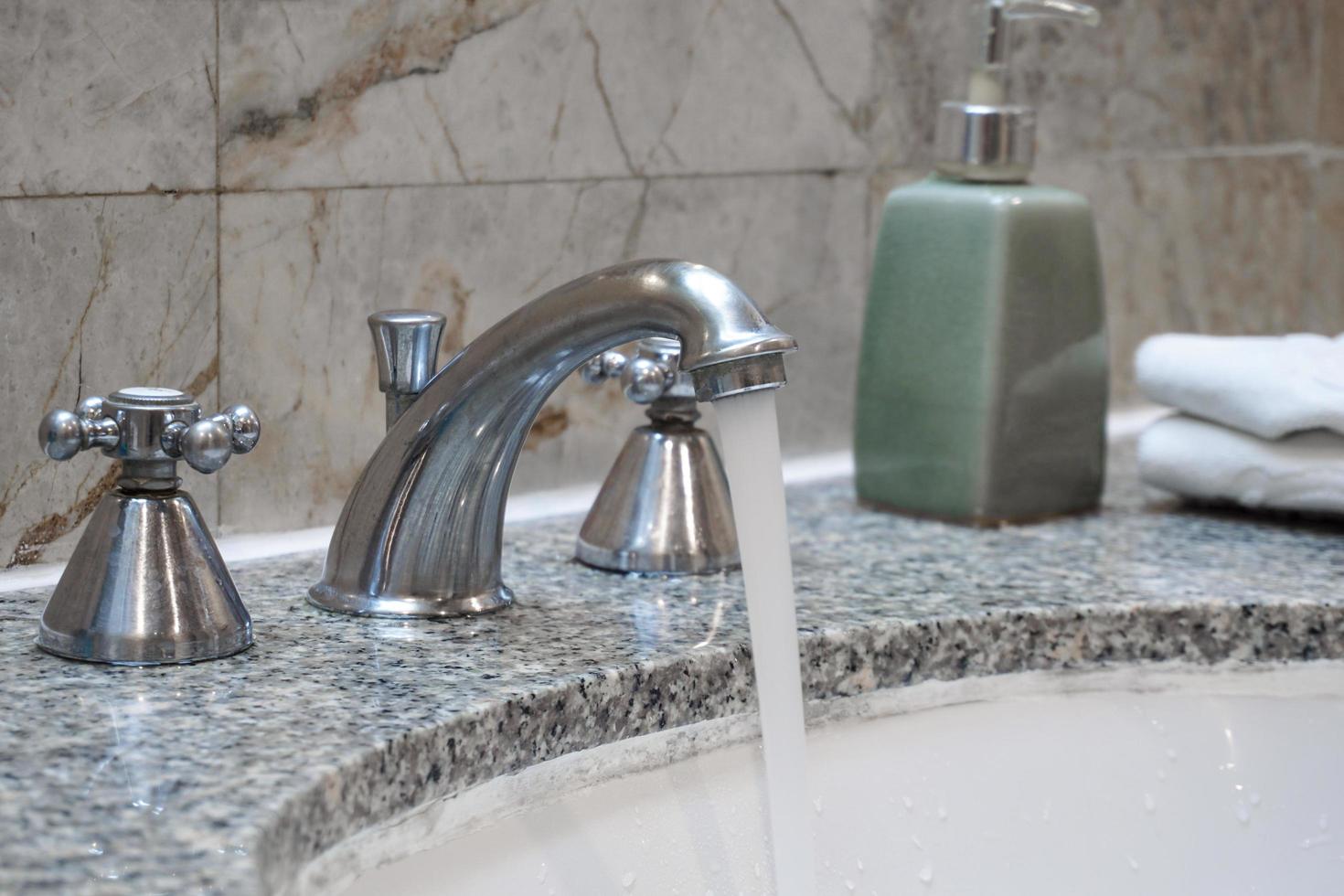 Close up the stainless faucet in the toilet. photo