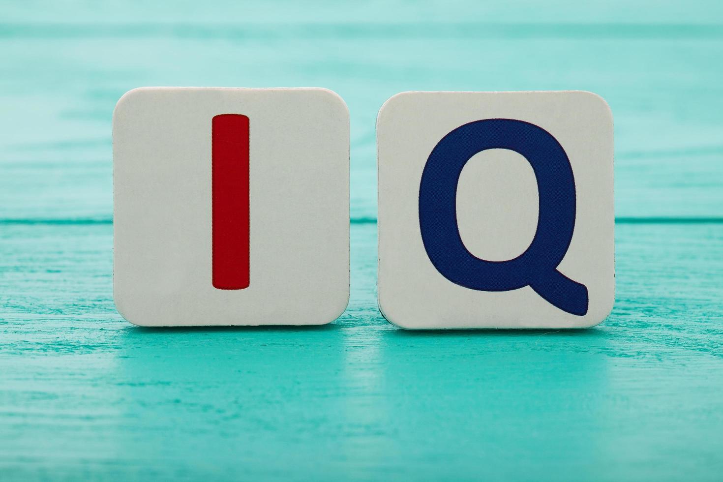 Intelligence quotient. Word IQ on blue wooden background. Copy space. Mock up. School and education concept. photo