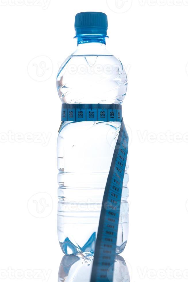 Bottle with water and measure tape photo