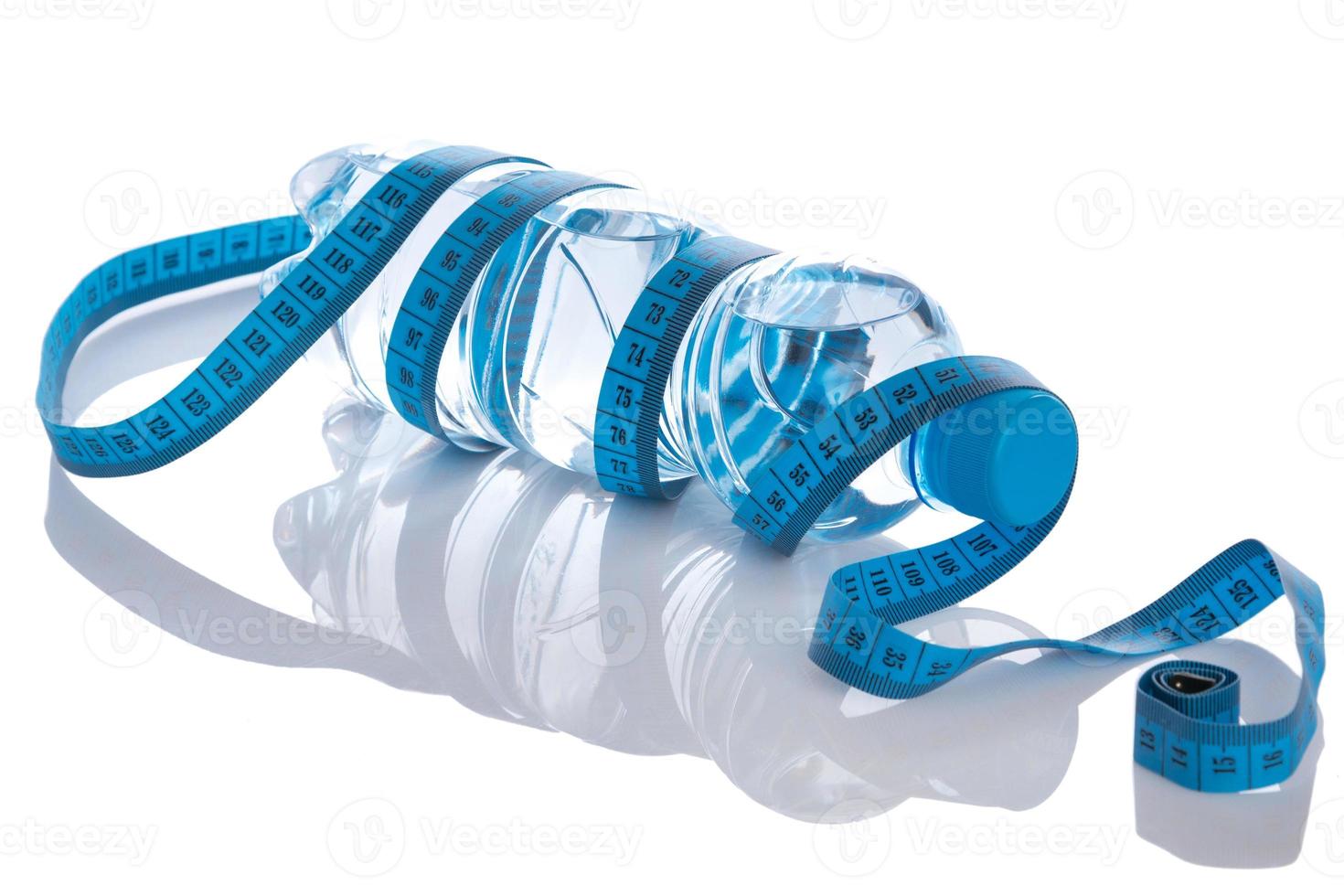 Bottle with water and measure tape photo