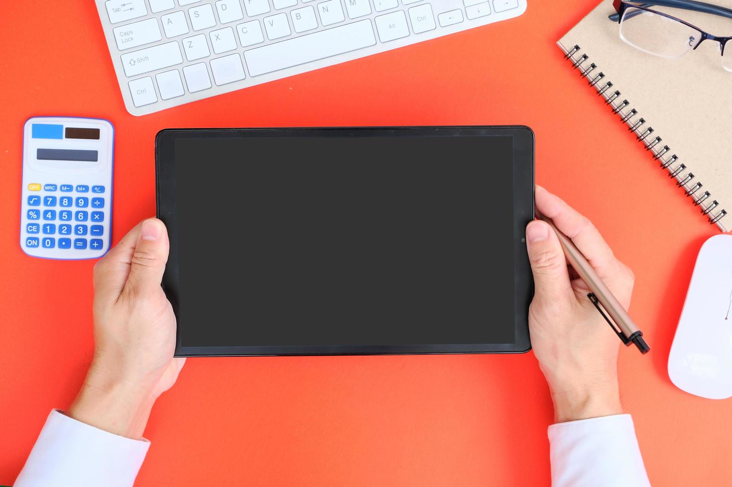 Blank tablet screen while typing on a keyboard, as well as a screen mockup for further customization, can be used for a variety of purposes. area for copying photo