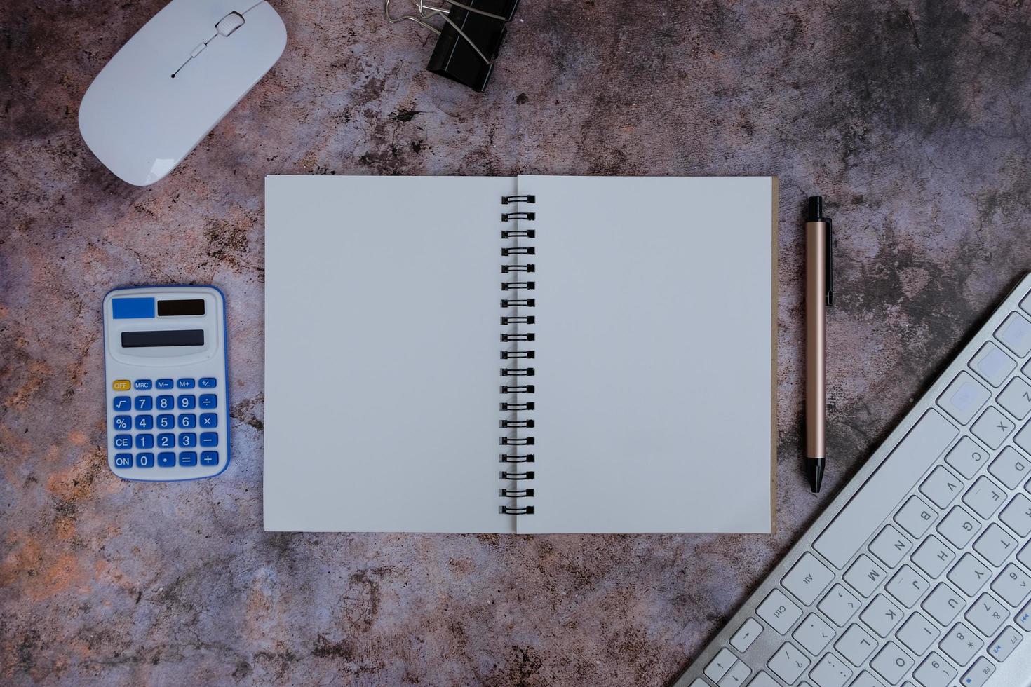 Laptop, smartphone, and supplies on a black office desk table. Computer tools on a desk table in the office, Top view with copy space, flat lay. photo