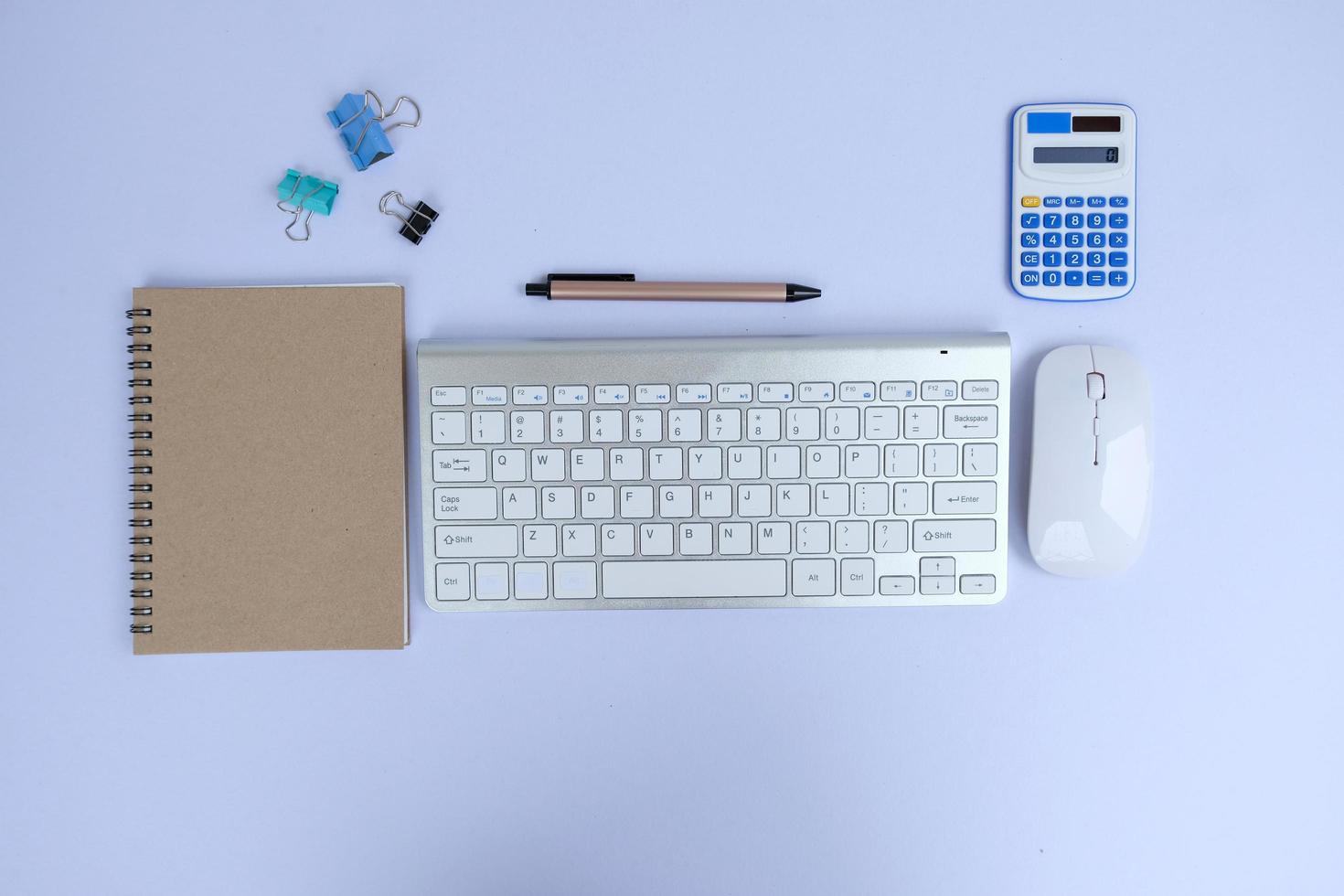 Laptop, smartphone, and supplies on a black office desk table. Computer tools on a desk table in the office, Top view with copy space, flat lay. photo