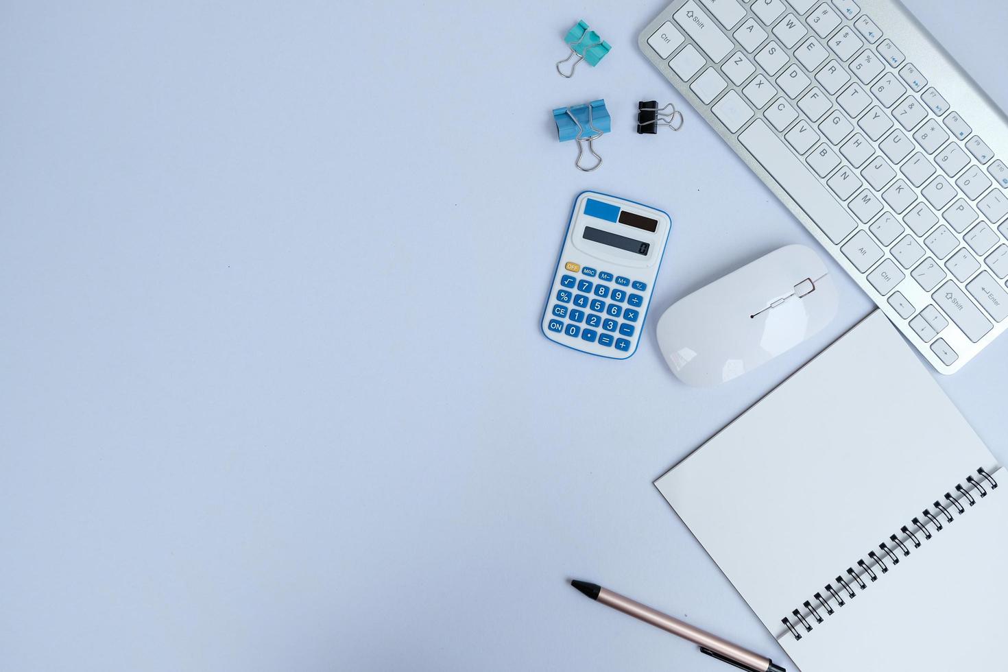 Laptop, smartphone, and supplies on a black office desk table. Computer tools on a desk table in the office, Top view with copy space, flat lay. photo