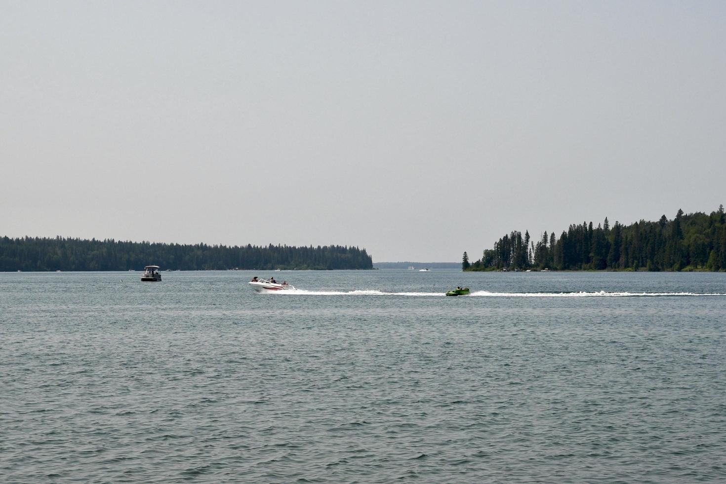 a motor boat pulling a rubber raft photo