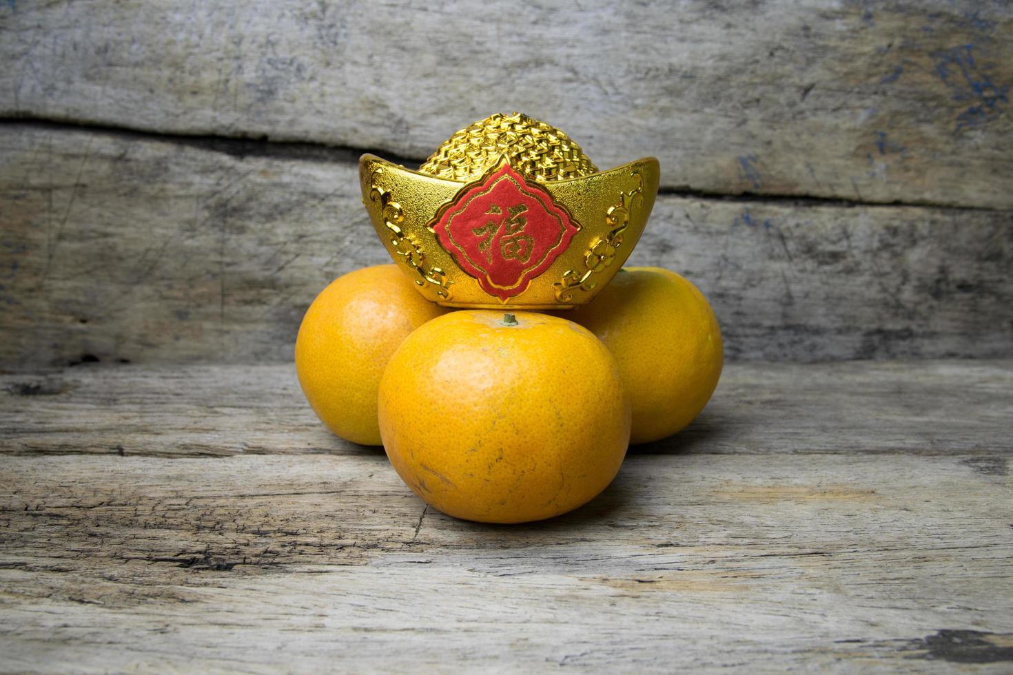 Mandarin oranges with decorative gold nugget photo