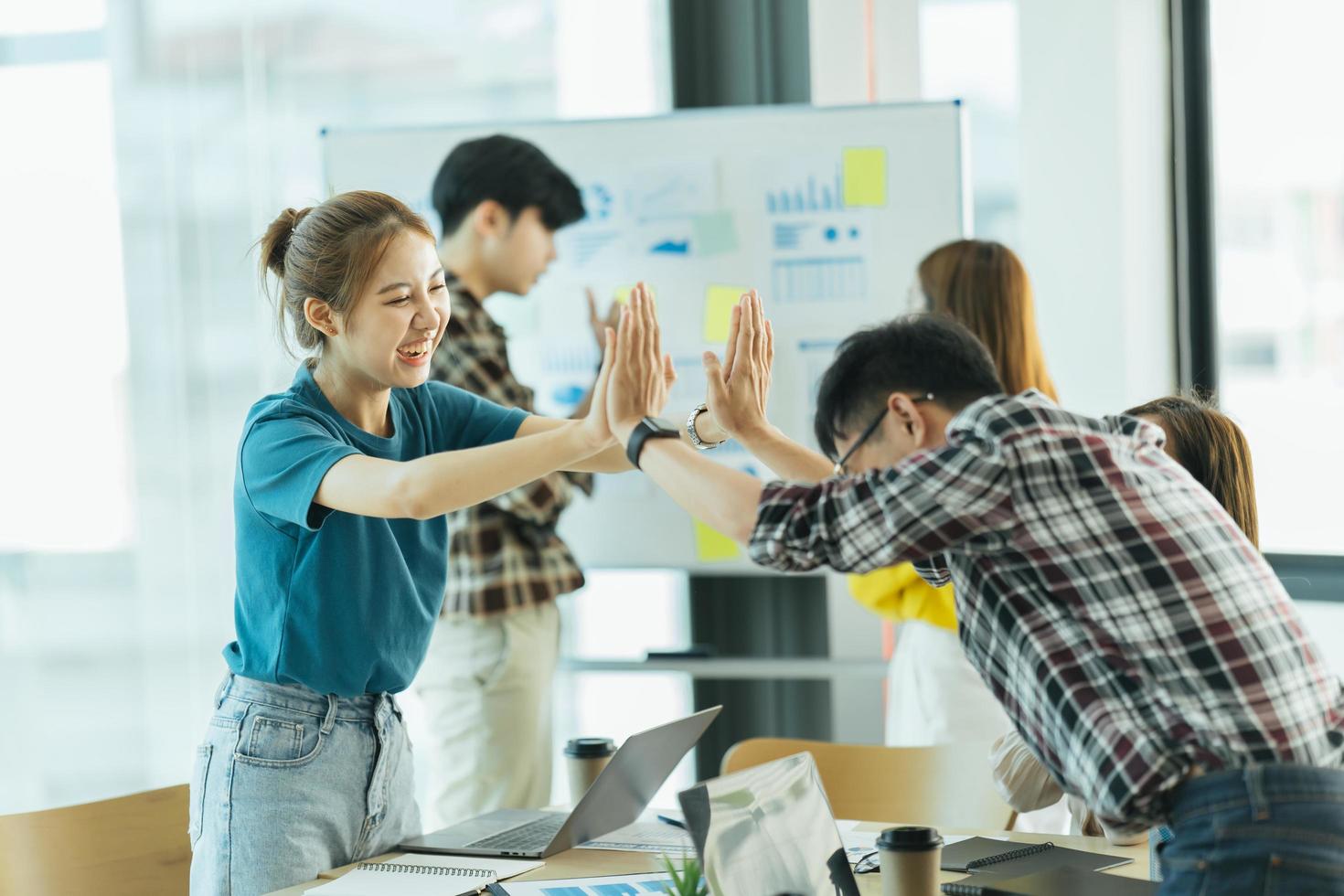 happy employees giving each other a high five. photo