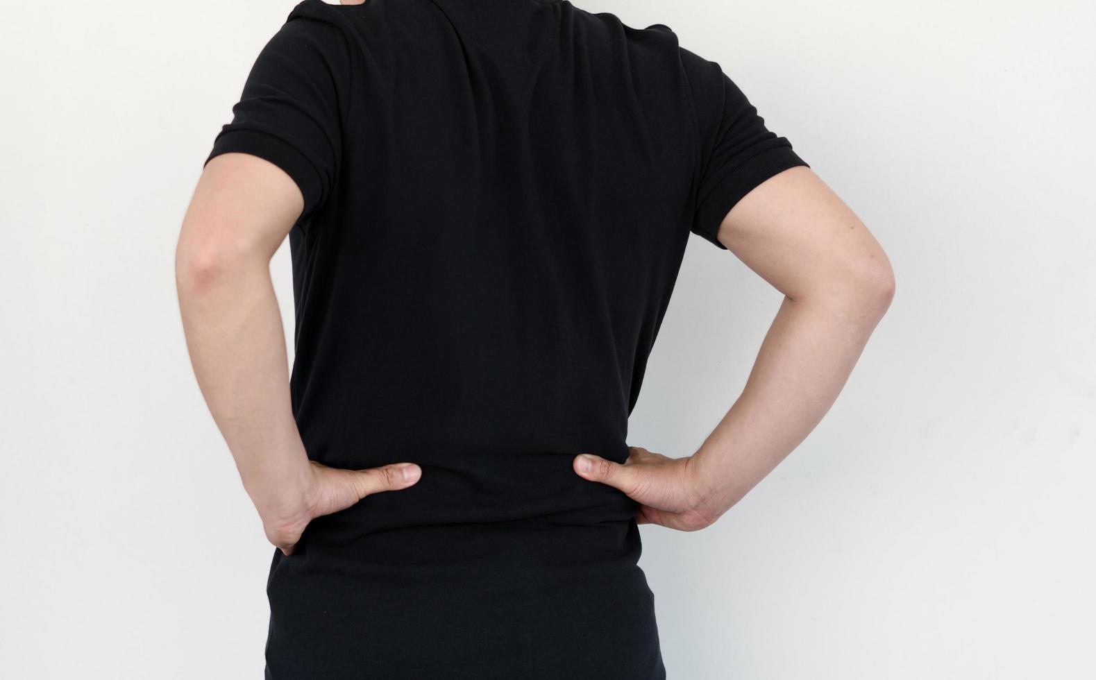 asian man with lumbar pain, backache and massage on waist to pain relief. photo