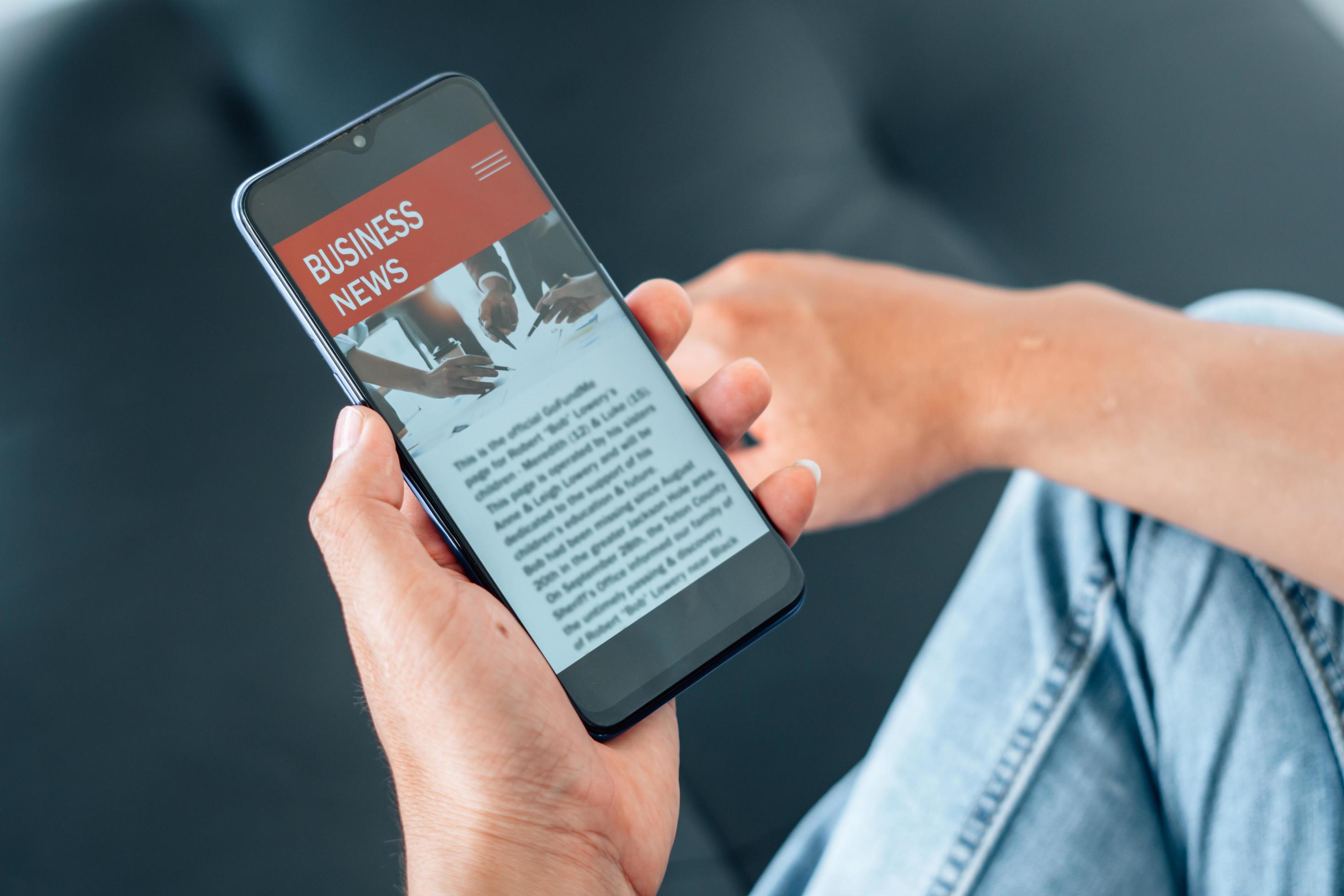 Mobile news application in smartphone. Man reading online news on