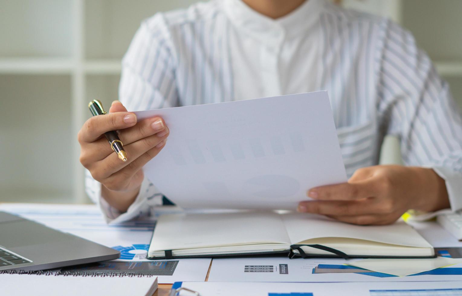 Close up of accountant or banker checking investment results, calculates financial savings, calculates annual taxes and economic concepts. Financial calculation concept. photo