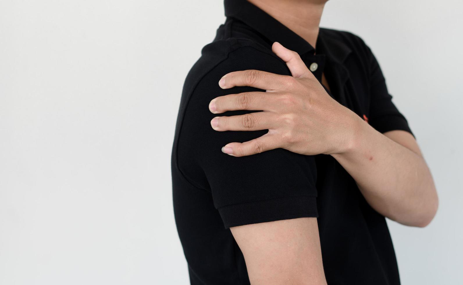 Healthcare concept, a man has severe shoulder pain due to overwork and office syndrome. photo