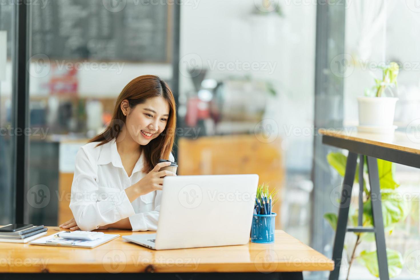 Online Meeting. Happy young woman using laptop computer for virtual conferencing, having video call at home. Cheerful Asian female communicating with colleagues, friends remotely. photo