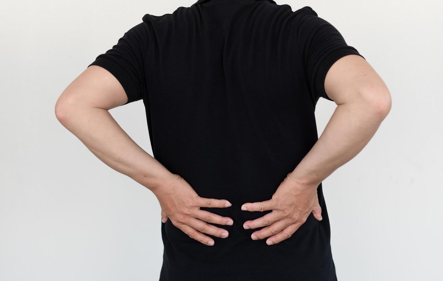 asian man with lumbar pain, backache and massage on waist to pain relief. photo