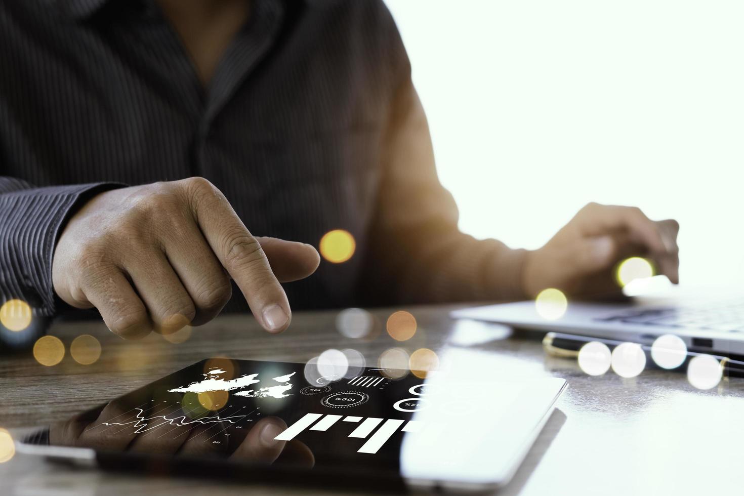 Business person analyzing financial statistics displayed on the tablet screen photo
